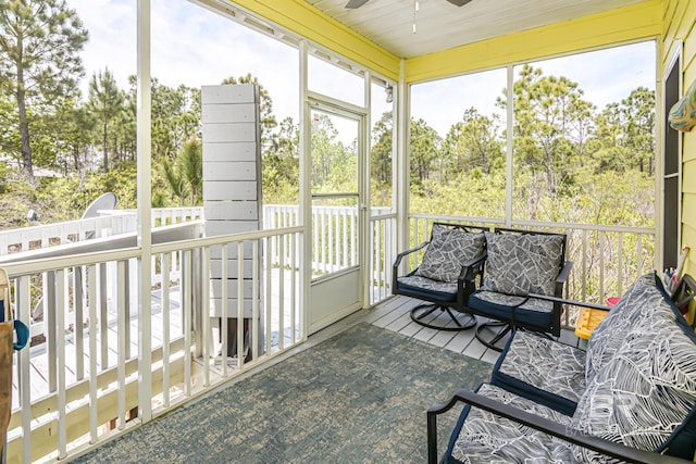 sunroom featuring a wealth of natural light and a ceiling fan