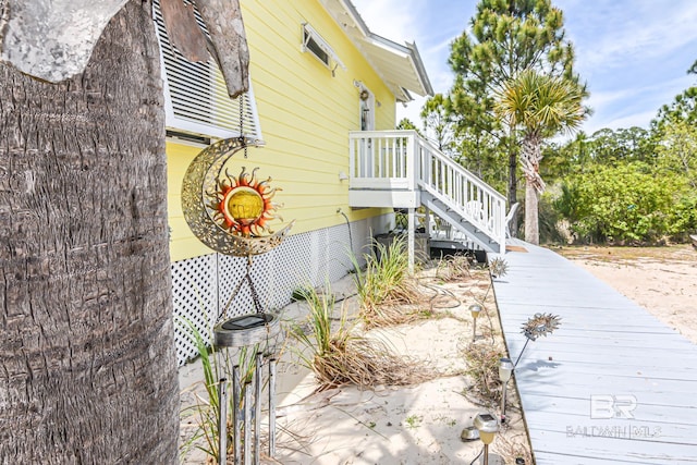 view of side of home featuring stairs