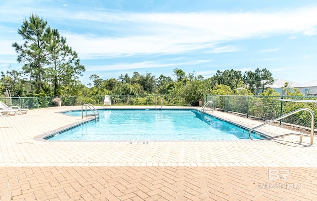 community pool featuring a patio area and fence