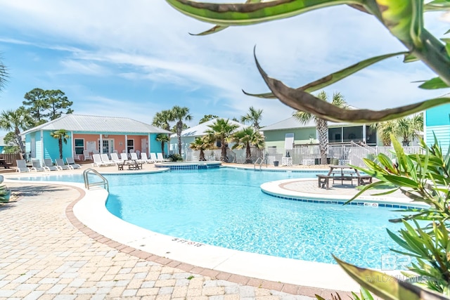 community pool featuring a patio area and fence