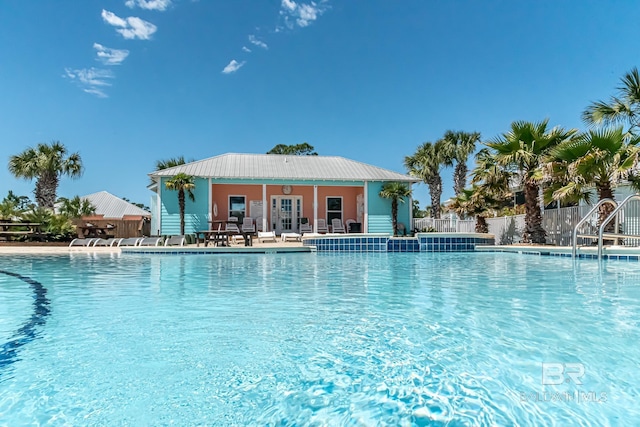 pool with fence and a patio