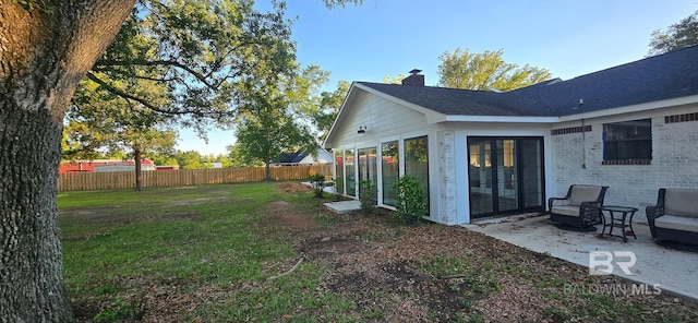 view of yard featuring a patio and a sunroom