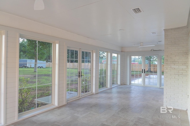 unfurnished sunroom featuring french doors
