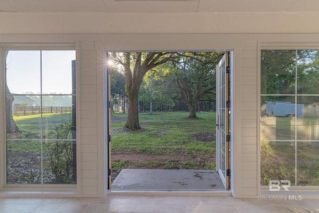 doorway to outside featuring tile patterned flooring