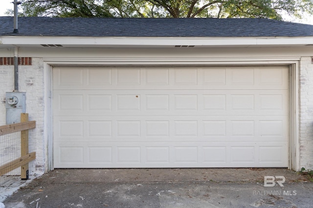 garage featuring asphalt driveway
