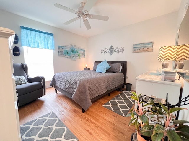 bedroom with ceiling fan and hardwood / wood-style flooring