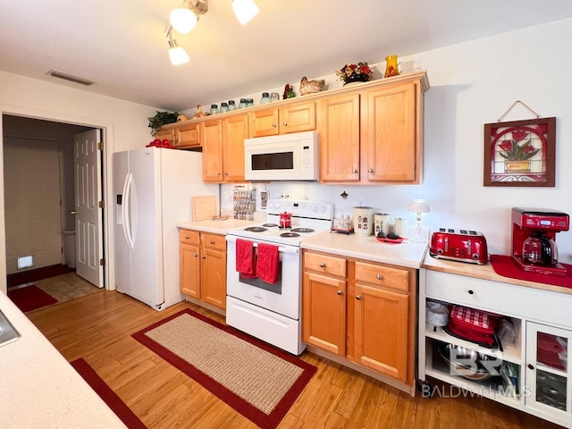 kitchen featuring white appliances and light wood-type flooring