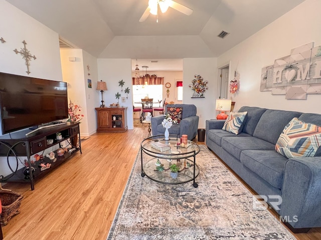 living room with wood-type flooring, ceiling fan, and vaulted ceiling