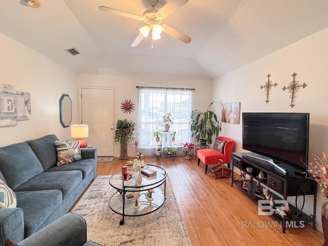 living room with vaulted ceiling, ceiling fan, and light hardwood / wood-style floors