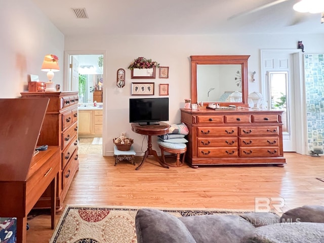 sitting room featuring ceiling fan, light wood-type flooring, and a wealth of natural light