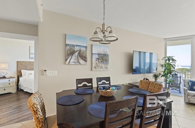 dining room featuring light hardwood / wood-style flooring and an inviting chandelier