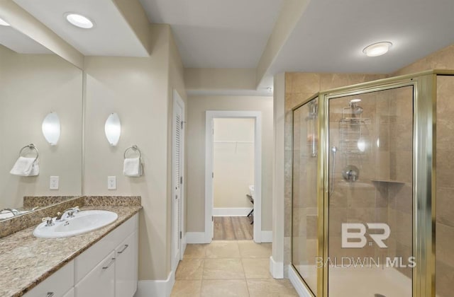 bathroom with vanity, tile patterned flooring, and an enclosed shower