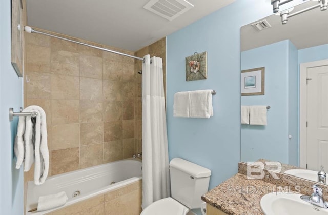 full bathroom featuring toilet, shower / bath combo with shower curtain, and vanity