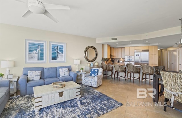 tiled living room featuring ceiling fan