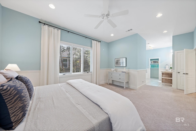 carpeted bedroom with a wainscoted wall, ceiling fan, visible vents, and recessed lighting