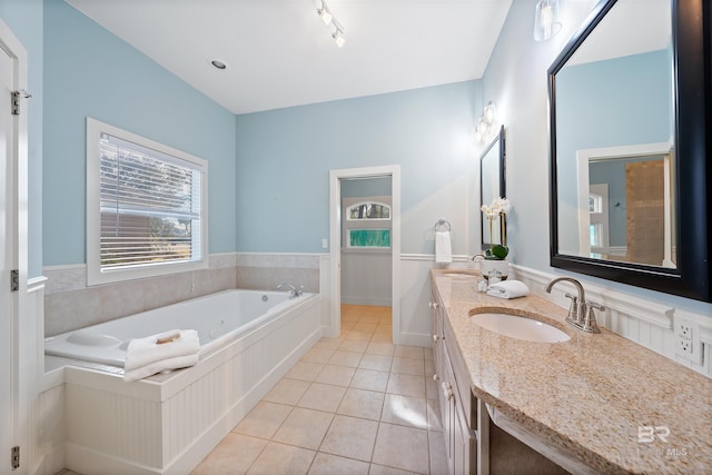 full bath with double vanity, a sink, a bath, and tile patterned floors