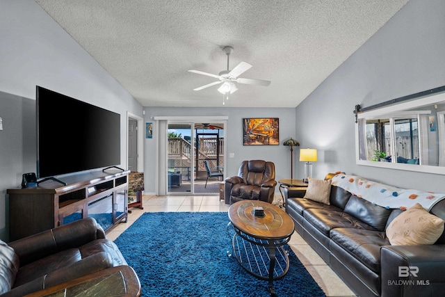 living area featuring light tile patterned flooring, a healthy amount of sunlight, a textured ceiling, and a ceiling fan
