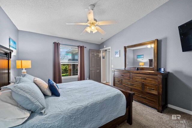 carpeted bedroom featuring a ceiling fan, baseboards, and a textured ceiling
