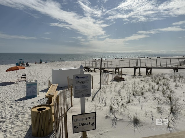 view of home's community with a beach view and a water view