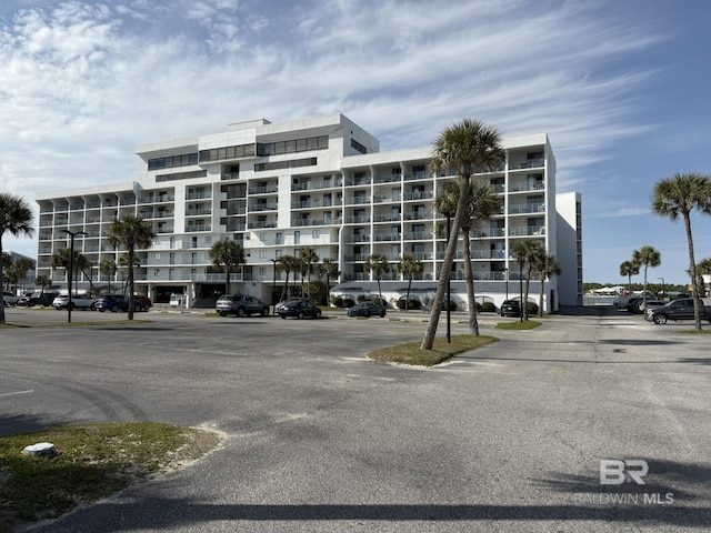 view of building exterior with uncovered parking