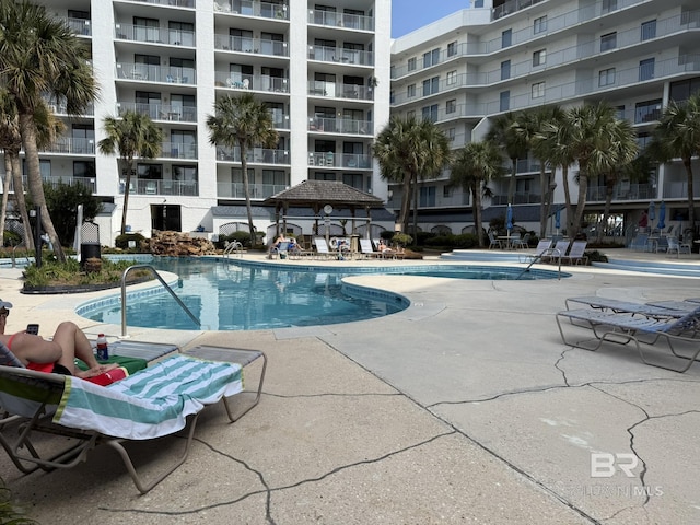 pool with a gazebo and a patio