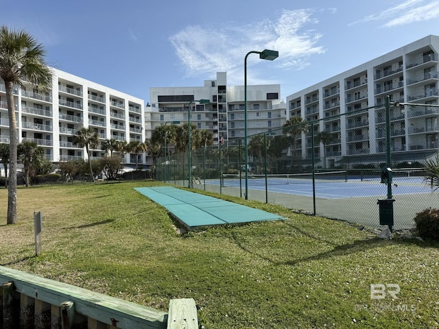 view of home's community featuring a lawn and fence