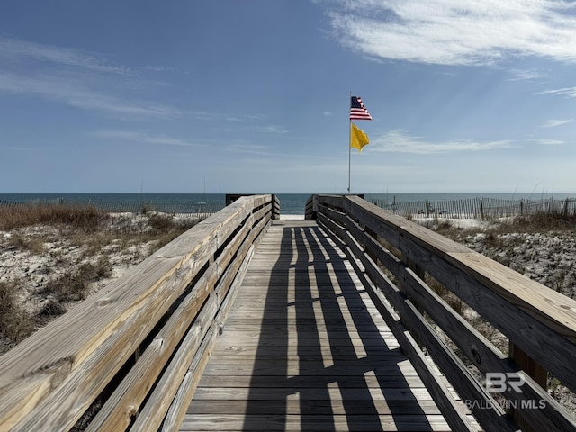 view of home's community with a water view and a beach view