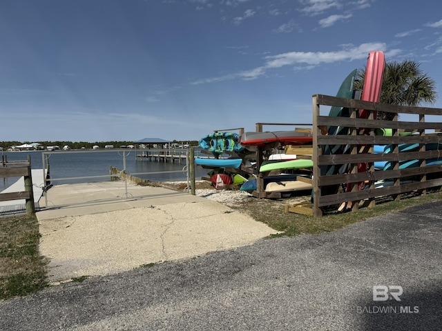 exterior space with a water view and a boat dock