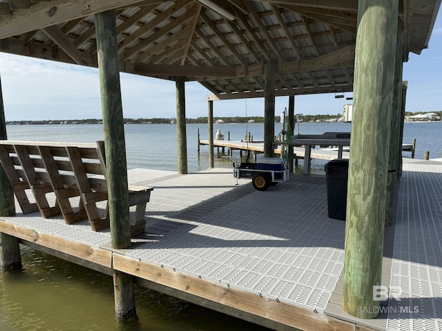 dock area with a water view and boat lift