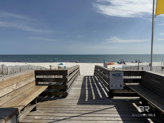 view of home's community featuring a water view and a view of the beach