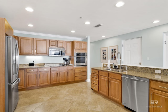 kitchen featuring visible vents, light stone countertops, stainless steel appliances, a sink, and recessed lighting