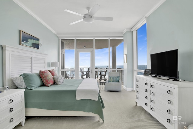 bedroom with ceiling fan, light carpet, access to outside, ornamental molding, and floor to ceiling windows