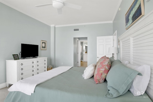 bedroom with visible vents, baseboards, ensuite bath, ceiling fan, and ornamental molding