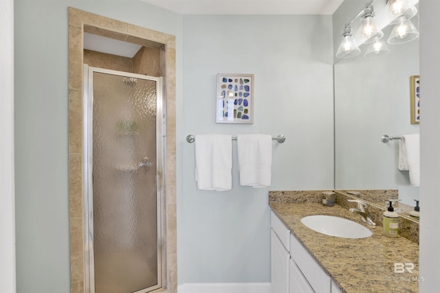 full bath with a stall shower and vanity