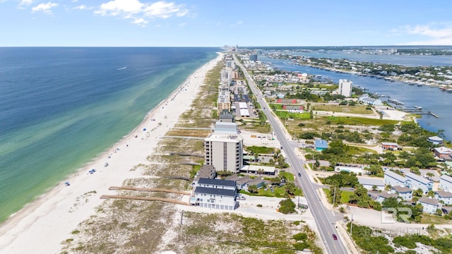 birds eye view of property featuring a water view and a beach view