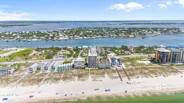 bird's eye view featuring a water view and a beach view