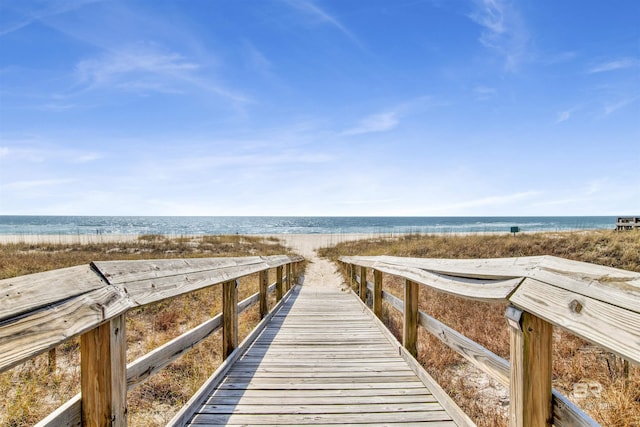 view of property's community featuring a beach view and a water view