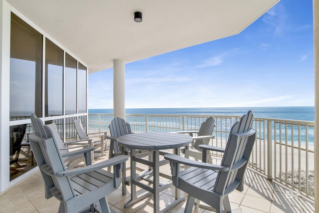 balcony featuring a beach view and a water view