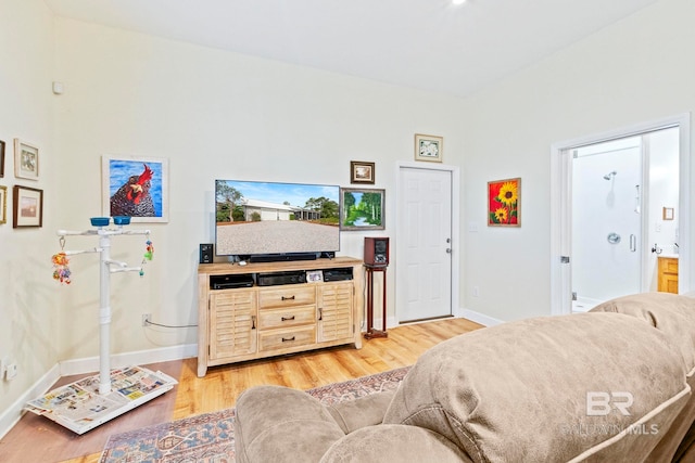 living area with light wood finished floors and baseboards