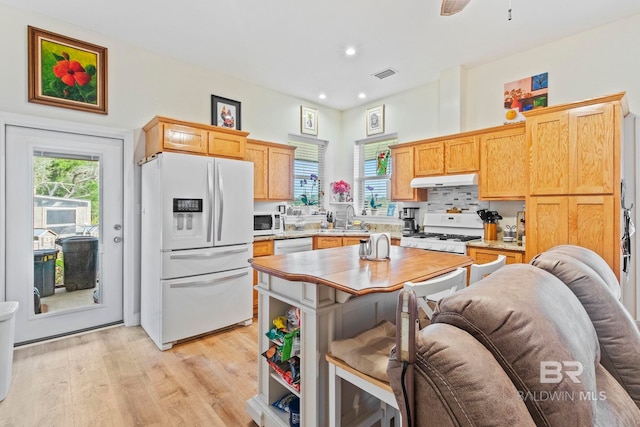 kitchen featuring light countertops, white appliances, a sink, and visible vents