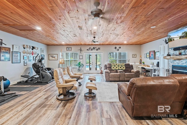 living room featuring french doors, a fireplace, visible vents, wood ceiling, and wood finished floors