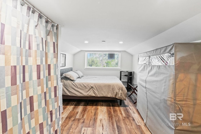 bedroom featuring vaulted ceiling and wood finished floors