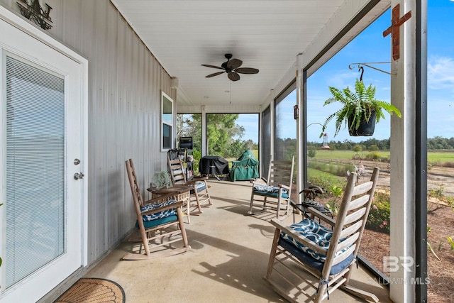 sunroom with a ceiling fan and a wealth of natural light