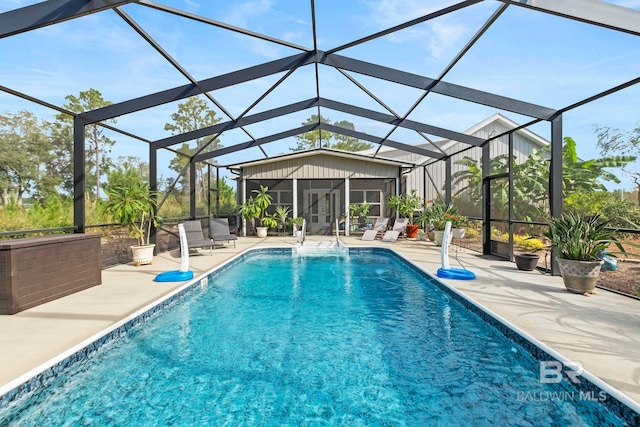 outdoor pool with glass enclosure and a patio area