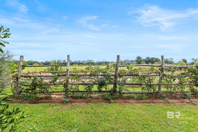 view of yard with fence and a garden