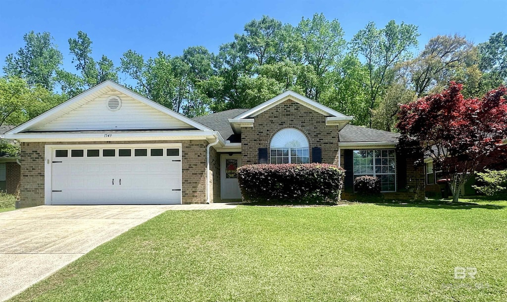 1549 E Augusta Dr, Mobile, AL 36695 - view of front of home featuring a garage, driveway, a front lawn, and brick siding
