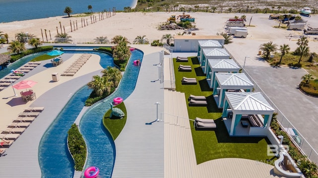 drone / aerial view of a pool and a nearby body of water