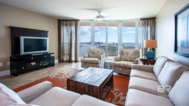 tiled living room with ceiling fan, plenty of natural light, floor to ceiling windows, and baseboards