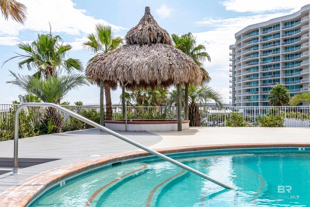 view of swimming pool featuring fence