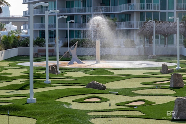 view of home's community featuring a putting area